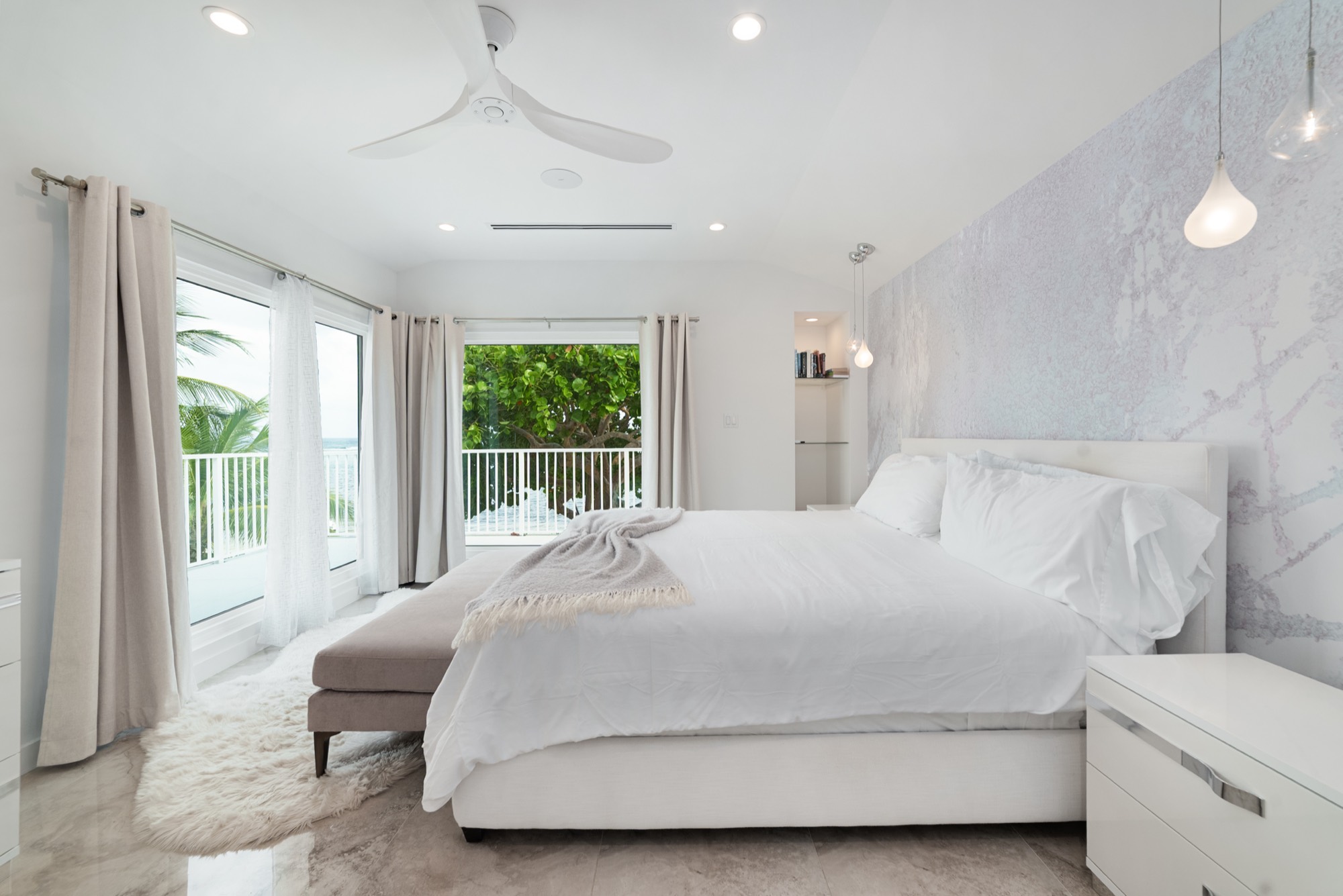 Primary bedroom with corner windows and ocean views