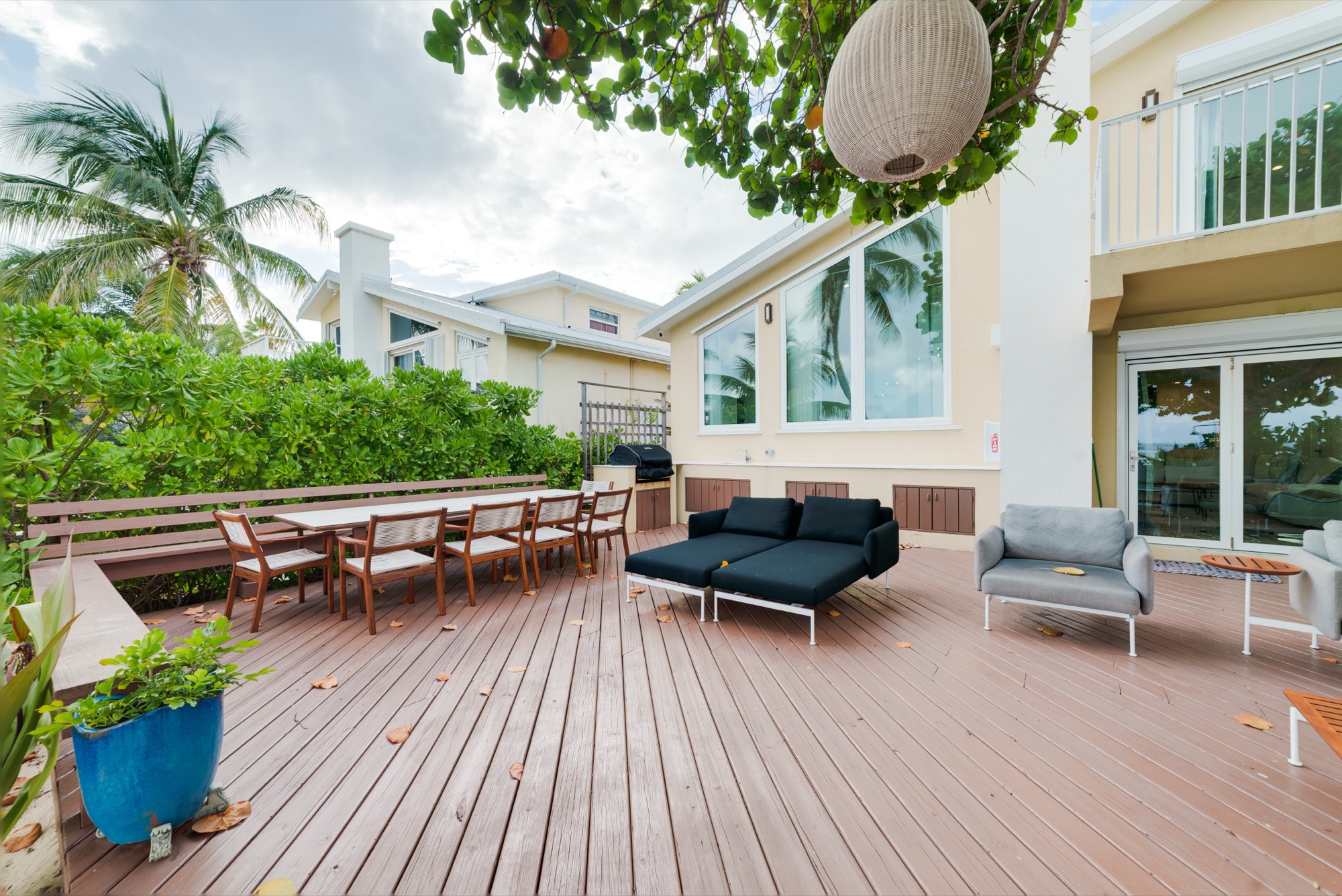 Oceanfront entertaining deck beneath a mature shade tree
